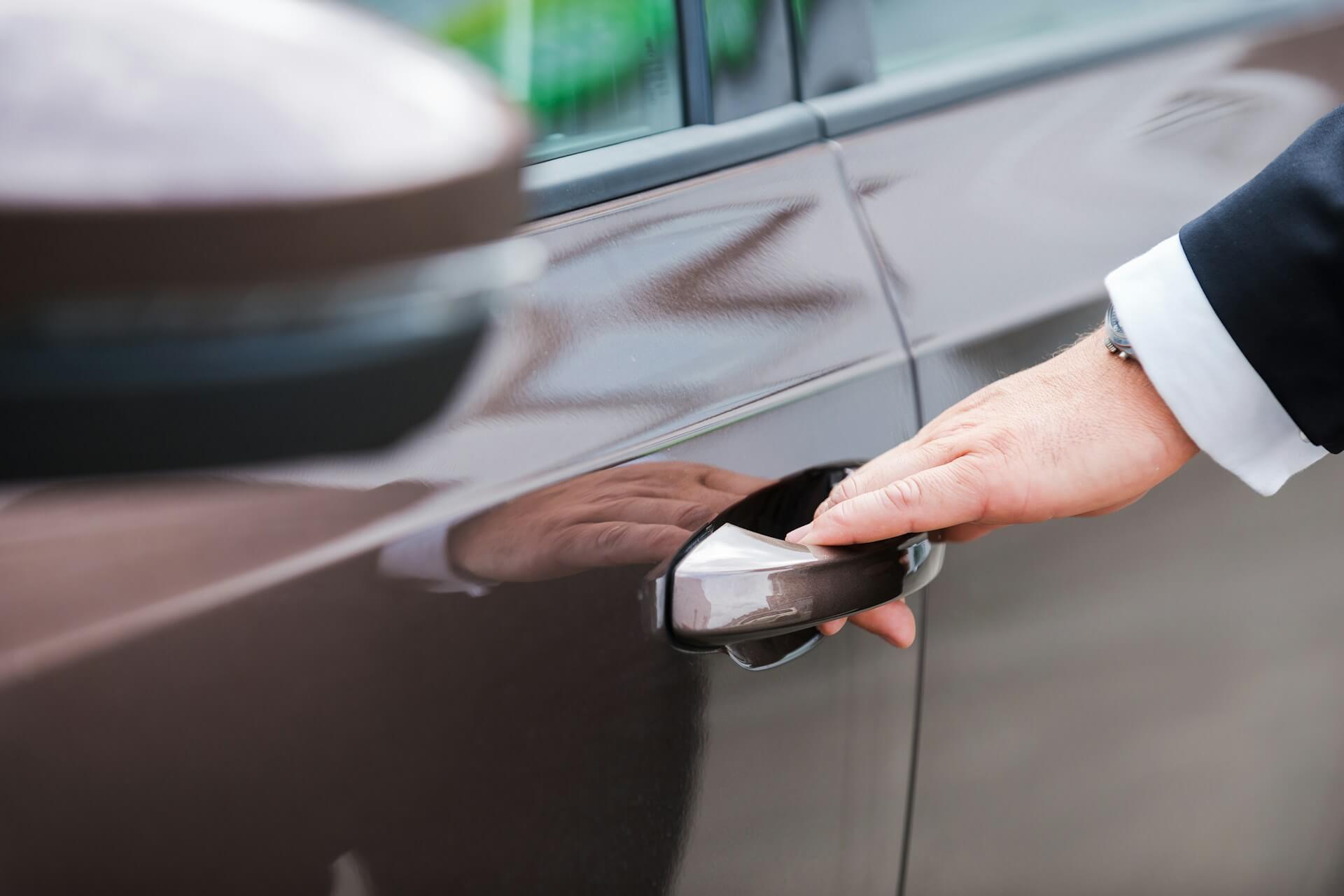 driver opening the door of his car